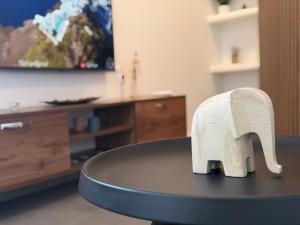 a white elephant statue sitting on top of a table at White Swallow Suite Santorini in Vourvoúlos