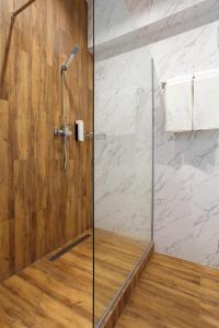 a shower with a glass door in a bathroom at Five seasons Family in Odesa +79 photos