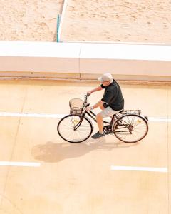a man riding a bike on a basketball court at GFH - Hotel Sole Resort in Marotta