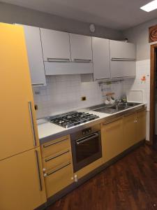 a kitchen with white cabinets and a stove top oven at Bis Jolly 1 in Cosenza