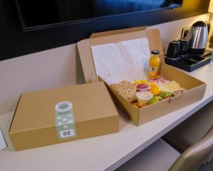 two boxes of food sitting on a table at Yuko Residence in Jasło +23 photos