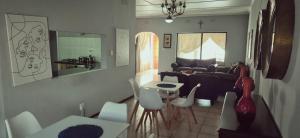 a living room with a couch and a table and chairs at Sthuli House in Empangeni