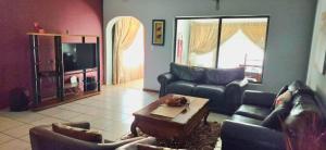 a living room with couches and a coffee table at Sthuli House in Empangeni