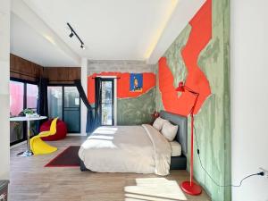 a bedroom with a bed and a painting on the wall at The Arch Casa - Design Hotel Pai ,Free Fast WiFi in Pai +105 photos