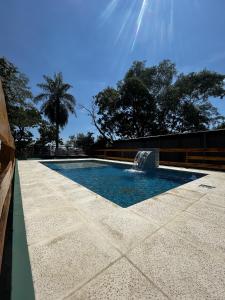 a swimming pool with a fountain in the middle at Piedra Alta Hotel & Restaurante in Itá Ibaté