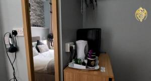 a room with a bedroom with a bed and a mirror at The Celtic Pride Hotel in Blackpool