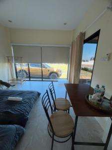 a dining room with a table and a car outside at Rimkuan Lakeview in Ban Kham Kom +17 photos