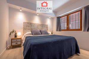 a bedroom with a large bed with a blue blanket at Palamós Blue Holidays in Palamós