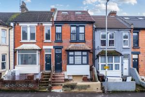 a row of brick houses with white doors at Gillingham Luxury, LNG GRAIN, Workers, Parking, Flexible Weekly Deals in Gillingham