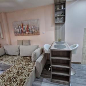 a living room with a couch and a table at Square Apartment in Paraćin