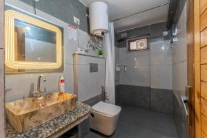 a bathroom with a sink and a toilet at Moustache Hostel Nainital in Nainital +25 photos