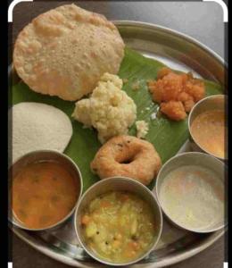 a plate of food with different types of food on it at KSTDC Hotel Mayura Gerusoppa, Jogfalls in Māvingundi
