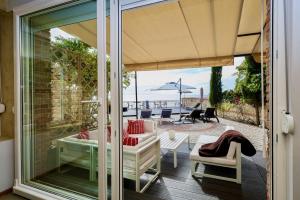 a screened in porch with a view of the ocean at Villa Alenor – Sea View & Beach Access in Nesebar