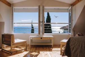 a bedroom with a window with a view of the ocean at Villa Alenor – Sea View & Beach Access in Nesebar +21 photos