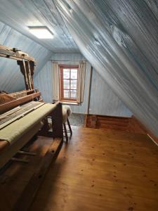 a bedroom with a bed in a room with a window at Vahtramäe saun in Siniküla