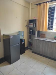 a kitchen with a refrigerator and a counter top at GCG STAYS ltd in Mtwapa