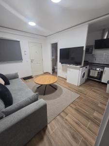 a living room with a couch and a table at Las vegas in Alcorcón +4 photos