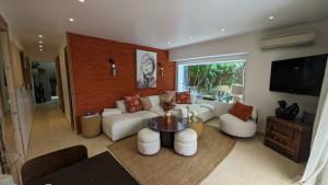 a living room with a couch and a table at Solenzia, appartement luxueux à 100m de la plage in Saint-Tropez