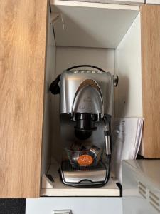 a coffeemaker sitting in a drawer in a kitchen at Domek nad Strugą przy stawach 10 km od Warszawy" Jacuzzi na zamówienie" in Halinow