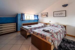 a bedroom with two beds and a dresser in it at Viewpoint House in Alzano Lombardo