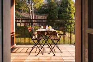 a table and chairs sitting on a porch with a view at Viewpoint House in Alzano Lombardo