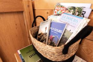 a basket filled with books on a table at Gite du Brin d'Herbe in Pontarlier