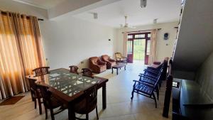 a living room with a table and chairs at The Kandy City Townhouse in Kandy