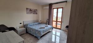 a bedroom with a bed and a tub and a window at Mara casa vacanza in Maracalagonis