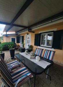 a patio with a table and chairs and a house at Apartments Anđela in Skradin