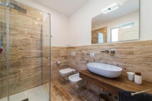 a bathroom with a sink and a toilet and a shower at Villa di Sogno in Palazzo