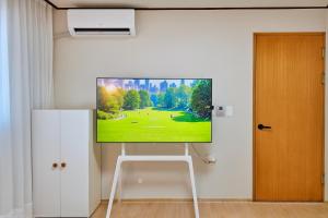a flat screen tv hanging on a wall at Sai-gil stay in Busan
