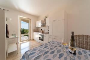 a kitchen with a table with a bottle of wine at Villa di Sogno in Palazzo