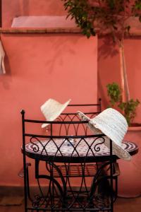 a table with two umbrellas on top of it at Riad Allal in Marrakesh