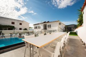 a patio with a table and chairs and a swimming pool at Villa A'Mare in Seget Vranjica