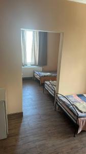 a room with three bunk beds and a window at Motel Ararat in Rava-Rusʼka
