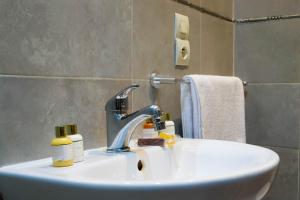 a bathroom sink with a faucet and towels at Riad Allal in Marrakesh +103 photos