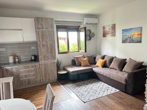 a living room with a couch and a table at Apartman T&T in Cetinje