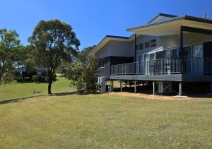 a large house with a yard in front of it at Beltana Villas in Pokolbin