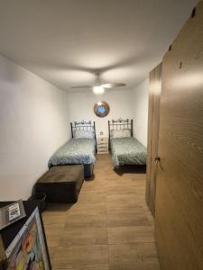 a room with two beds and a ceiling at Casa de los Suenos Granada in El Turro