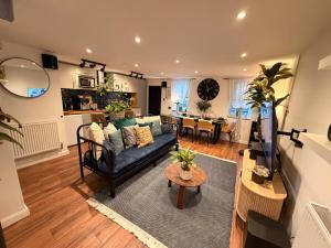 a living room with a couch and a table at Cozy Cottage Coventry self check-in after 3pm, Pets Friendly in Longford