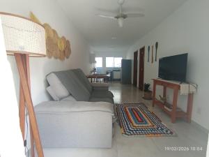 a living room with a couch and a television at Casa Lego Paraty in Paraty