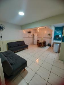 a living room with two couches and a table at Aconchego famíliar in Mongaguá
