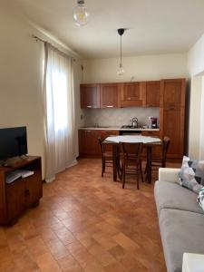 a kitchen and living room with a table and a couch at Casa Rasiglia 3 House Relax in Casenove +14 photos