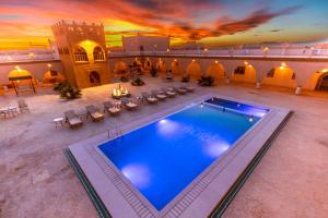 an overhead view of a swimming pool in a building at Hotel Sunset Palace in Merzouga
