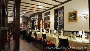 a dining room with tables and chairs in a restaurant at Das Lamm Heidelberg in Heidelberg