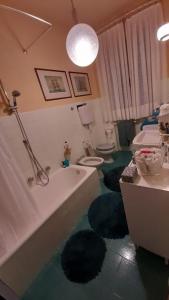 a bathroom with a tub and a sink and a toilet at Gioiello sul mare in Ospedaletti +5 photos