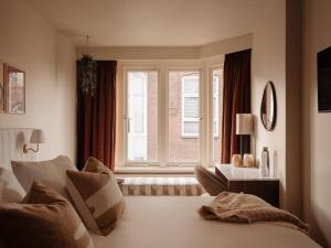 a bedroom with a bed and a large window at Adam's Museum House in Amsterdam