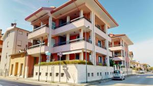 a building on the side of a street at Residence Magnolia in Grado