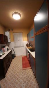 a kitchen with a black refrigerator and a sink at Gioiello sul mare in Ospedaletti