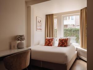 a hotel room with a bed and a window at Adam's Museum House in Amsterdam